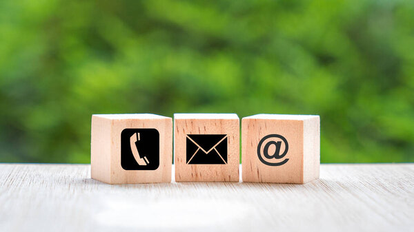Wood block cube symbol telephone, email, address. Website page contact us or e-mail marketing concept