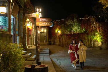 Beijing, China - Oct 22nd, 2024: Street view of Gubei Water Town during the night. A famous travel destination. clipart