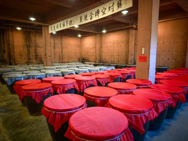 Beijing, China - Oct 23rd, 2024: Rows of wine pots in Sima Small Shochu Brewery aka Sima Xiaoshao in Gubei Water Town, Beijing. clipart