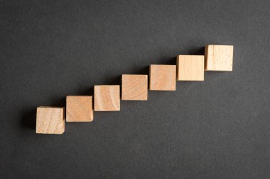 Yedi boş kare tahta blok, arka planda kısa adımlarla yukarı. Üst görünüm.