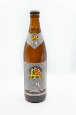 Kyiv, Ukraine - October 02, 2021: Studio shoot of German ABK Pils beer bottle closeup against white background.