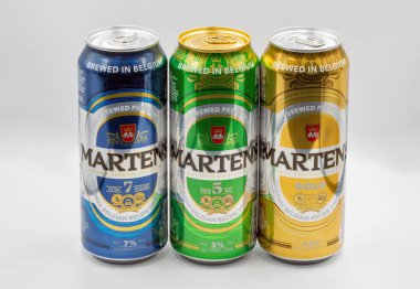 Kyiv, Ukraine - June 18, 2022: Studio shoot of Martens Gold, Extra 7 and Premium 5 Belgian beer cans closeup against white. Martens family brewers since 1758.