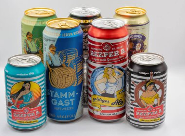 Kyiv, Ukraine - June 18, 2022: Studio shoot of German Reeper B Golden Ale, Indian Pale Ale, Baltic Porter, Apostel and Stamm-Gast beer cans closeup on white.