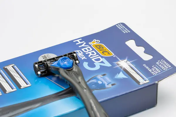 stock image Kyiv, Ukraine - March 29, 2024: Studio shoot of Bic Hybrid Flex shaving razors machine with replaceable cassette blades closeup on white. Bic produces stationery, lighters, and shaving razors.