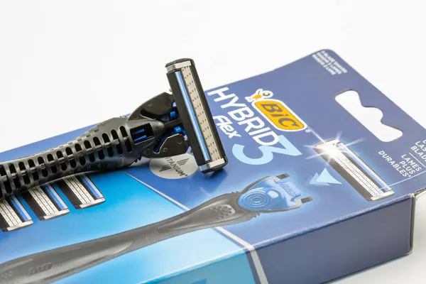 stock image Kyiv, Ukraine - March 29, 2024: Studio shoot of Bic Hybrid Flex shaving razors machine with replaceable cassette blades closeup on white. Bic produces stationery, lighters, and shaving razors.