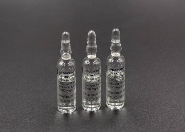 Kyiv, Ukraine - August 06, 2024: Studio shoot of Ferrer Takeda Citicoline Ceraxon solution for injections glass ampoules closeup on black. clipart