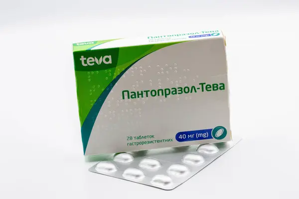 stock image Kyiv, Ukraine - August 23, 2024: Studio shoot of pantoprazole by Teva pack and blister closeup against white. It is mainly used for treatment of gastroesophageal reflux and peptic ulcer disease.