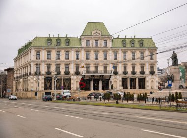 Iasi, Romania - December 26, 2024: Union Square with Grand Hotel Traian and Alexandru Ioan Cuza Statue created by the Italian sculptor Raffaello Romanelli. clipart