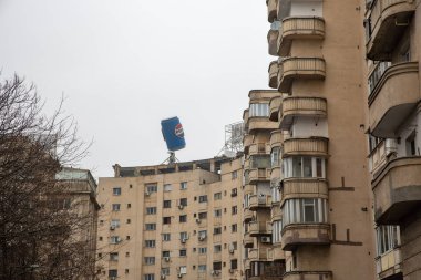 Bucharest, Romania - December 31, 2024: A huge advertising can of Pepsi on the roof of a residential building in downtown. Pepsi is a carbonated soft drink that is produced and manufactured by PepsiCo clipart