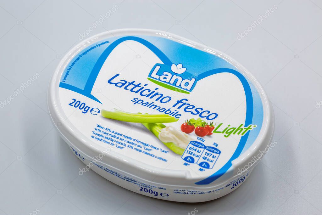 Porec, Croatia - May 20, 2025: Land fresh spreadable dairy product light container, showing its packaging design with tomatoes and green onions on a white and blue background closeup.
