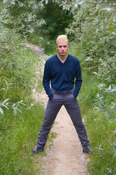 Blonde Young Man Looking Camera Hands Pockets Doing Bridge Legs — Stock Photo, Image