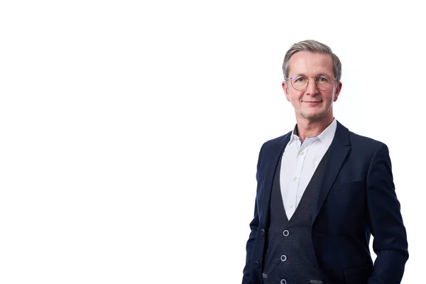 Smiling businessman portrait. Successful business man wearing dark suit while standing against at isolated white background.