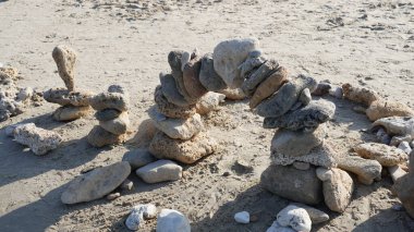 Balancing stones on sand. Zen Style Stones by the Sea