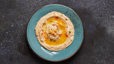 Hummus with olive oil, paprika, lemon and pita bread. Classic hummus on the plate