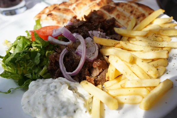 stock image Traditional greek, turkish meat food on pita bread and tzatziki. Gyros pita