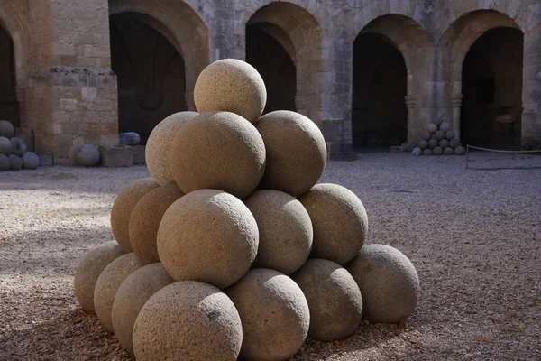 stock image Stone cannonballs in the courtyard of the archaeological museum on the island of Rhodes. Old town of Rhodes, Greece