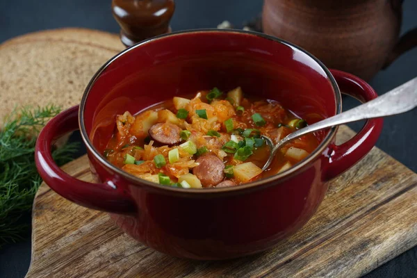 Czech cabbage soup Zelnacka or  Bohemian cabbage soup with potatoes, smoked bacon, sausages and vegetables