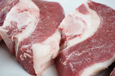 Kemikli taze çiğ biftekler Asado pişirmeye hazır.