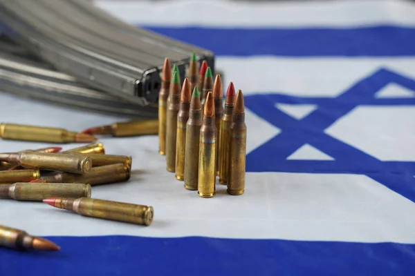 Ammunition from the gun. Bullets and magazines. Lend-Lease concept. Army concept. Israeli flag on the background.