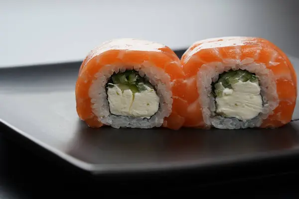 Stock image Philadelphia Sushi Rolls with Salmon and Cream Cheese on a black background