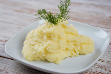 Tahta masada servis edilen taze dereotlu patates püresi.