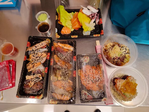 stock image appetizing trays of oriental food with sushi, prawns, various fried for dinner or lunch