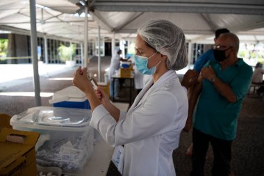 Rio de Janeiro, Brezilya - 19 Mart 2021: 75 yaşındaki erkekler Rio de Janeiro.Coronavirus 'un kuzey bölgesindeki UERJ Kampüsü Maracan' da CoronaVac ile aşılandılar.