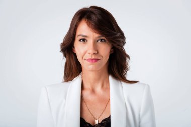 Çekici orta yaşlı bir kadının portresi. Dişli bir gülüşü var. Ceket giyiyor. Uzayı kopyala Stüdyo çekimi.