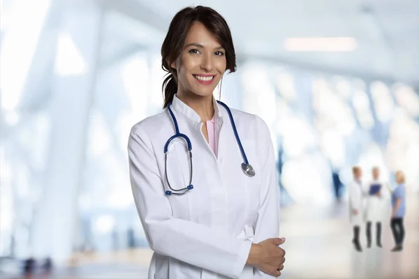 Portrait Smiling Female Doctor Arms Crossed Standing Hospital Foyer Confident — Stock Photo, Image