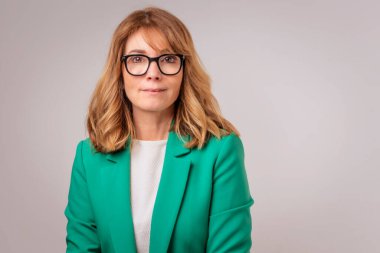 Orta yaşlı bir iş kadınının portresi. Ofiste duran kendine güvenen profesyonel bir kadın..