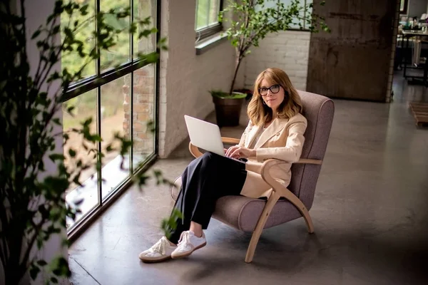 Woman Sitting Armchair Using Laptop Work Attractive Female Wearing Blazer Stock Photo
