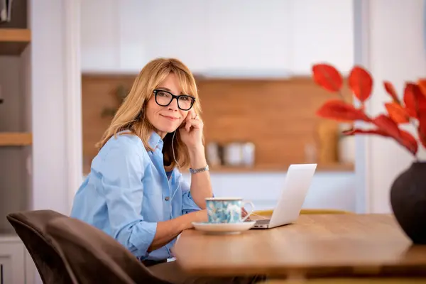 Blond Haired Woman Sitting Home Usining Laptop Earphone Work Home Stock Photo