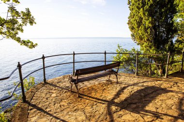 Viewpoint by the sea with bench at the Adriatic sea. clipart