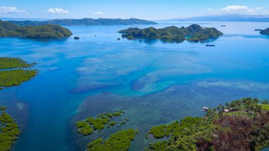 Overlooking Tagana-an and the mangrove forests looking towards Tinago Islet and the Blue Lagoon. Surigao Del Norte, Philippines.  clipart