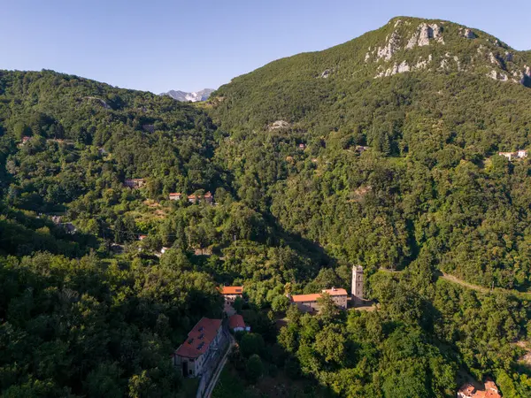 stock image Sant'Anna di Stazzema, Italy - Jul 16 2024: the Memorial Ossuary monument to the victims of the Nazi-fascist massacre and Apuan Alps view