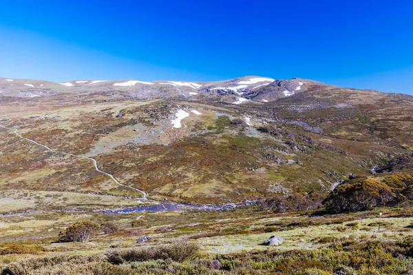 Landscape views over the Snowy River towards Main Range Walk on a summers day in Kosciuszko National Park in Snowy Mountains, New South Wales, Australia