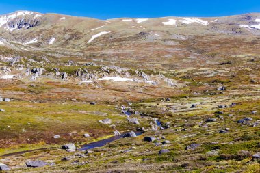 Landscape views over the Snowy River towards Main Range Walk on a summers day in Kosciuszko National Park in Snowy Mountains, New South Wales, Australia