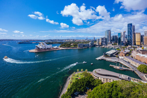 SYDNEY, AUSTRALIA - MARCH 4 2023: The Sydney CBD and surrounding harbour, including Circular Quay and The Rocks on a clear autumn day in Sydney, Australia