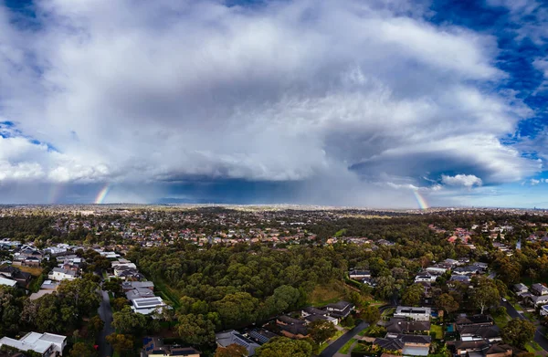 A winters day storm and rainbow aerial view over the estate of Springthorpe near Bundoora in Macleod, Melbourne, Australia