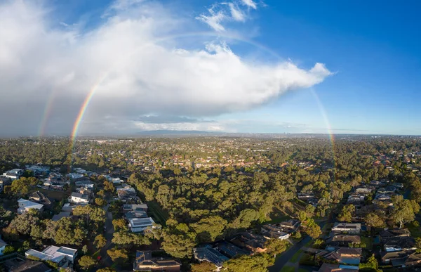 A winters day storm and rainbow aerial view over the estate of Springthorpe near Bundoora in Macleod, Melbourne, Australia