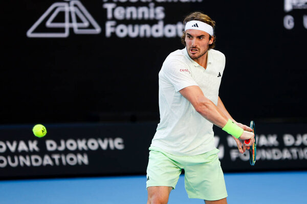 MELBOURNE, AUSTRALIA - JANUARY 11: Stefanos Tsitsipas of Greece plays against Novak Djokovic of Serbia during a charity match ahead of the 2024 Australian Open at Melbourne Park on January 11, 2024 in