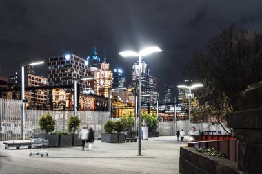 MELBOURNE, AUSTRALIA - JULY 5, 2024: Flinders Walk and Melbourne skyline as seen at dusk from Queens Bridge near Southbank in Melbourne, Victoria, Australia clipart