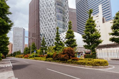 TOKYO, JAPAN - MAY 19 2019: Mode Gakuen Cocoon Tower during the day in Shinjuku, Tokyo clipart