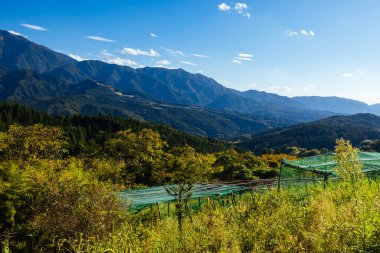 Hiking path landscape on the famous Magome-Tsumago Trail as part of the Nakasendo Way between Magome and Tsumago in Gifu Prefecture, Japan clipart