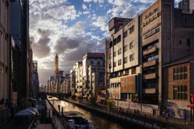 OSAKA, JAPAN - SEPTEMBER 24 2024: The view down Dotonbori River from Nipponbashi Bridge on a clear autumn evening in Osaka, Japan clipart