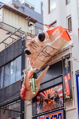 OSAKA, JAPONAN - 24 SEPTEMBER 2024: Osakas 'ın ünlü Dotonbori bölgesi ve Japonya' nın Osaka kentinde hareket eden ıstakozlar da dahil olmak üzere pek çok restoran ve ikonik gıda tabelaları