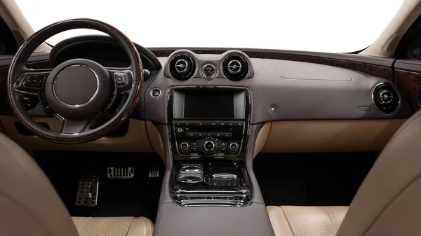 Luxury car interior. Multimedia screen and panel with control buttons. Modern car inside.