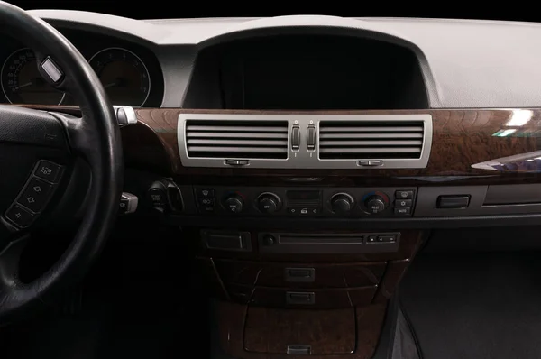 Classic prestige car inside. Multimedia screen close-up. Interior detail.