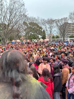 Tokyo, Japan - 23 Mar 2024: Indian crowd celebrating Holi Festival at Shinden-no-Mori Park at Rang barse Tokyo Holi event 