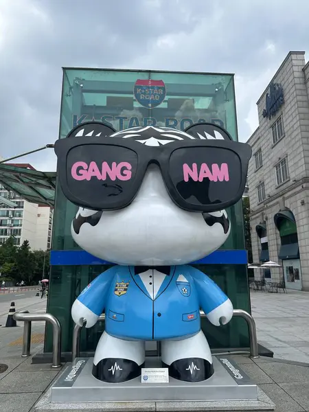 stock image Seoul, South Korea - 10 Aug 2024: Gangnam doll on Kstar road wearing glasses with Gangnam writing on it.